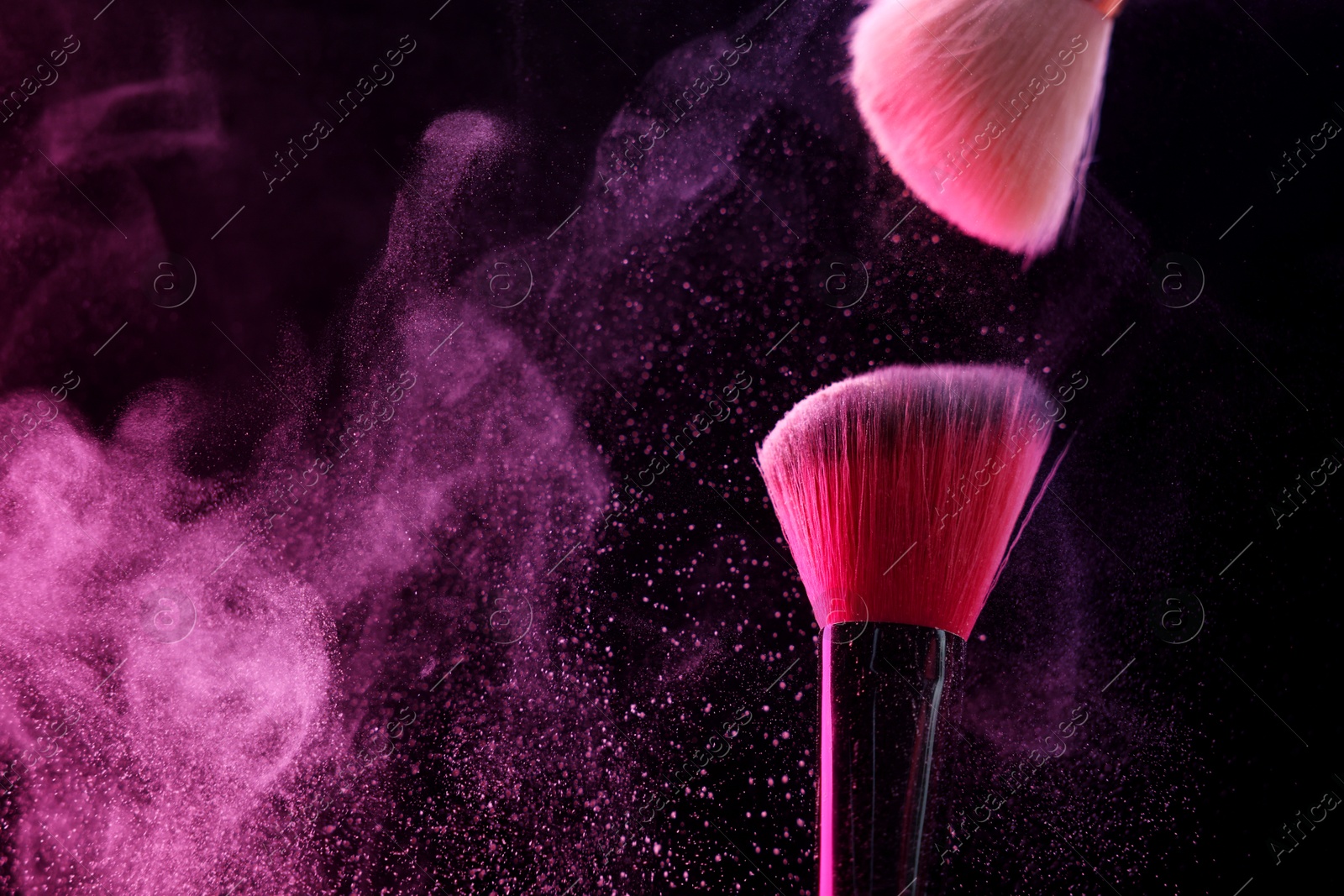 Makeup brushes with pink eye shadow on black background, closeup. Space for text Photo of Makeup brushes with pink eye shadow on black background, closeup. Space for text