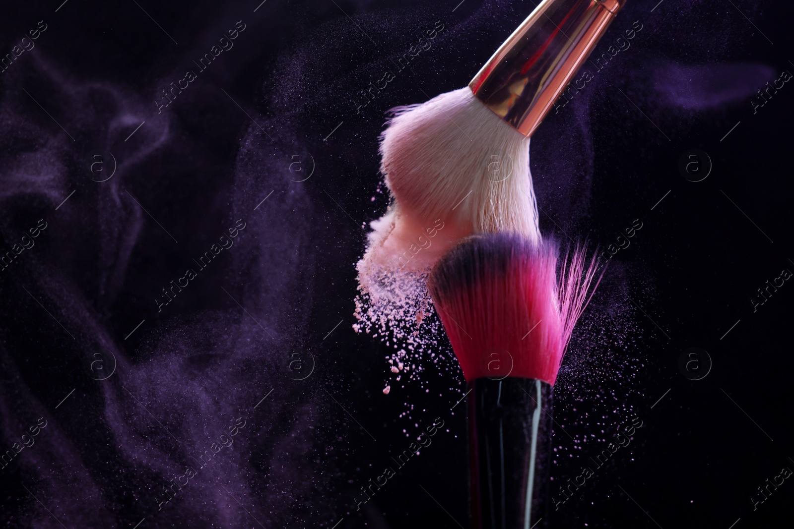 Makeup brushes with purple eye shadow on black background, closeup. Space for text Photo of Makeup brushes with purple eye shadow on black background, closeup. Space for text