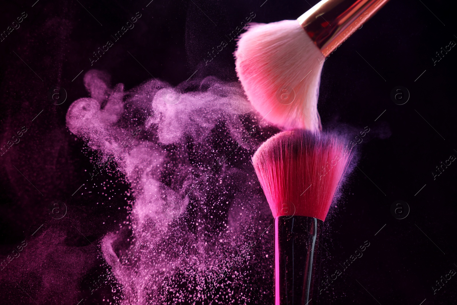 Makeup brushes with pink eye shadow on black background, closeup. Space for text Photo of Makeup brushes with pink eye shadow on black background, closeup. Space for text