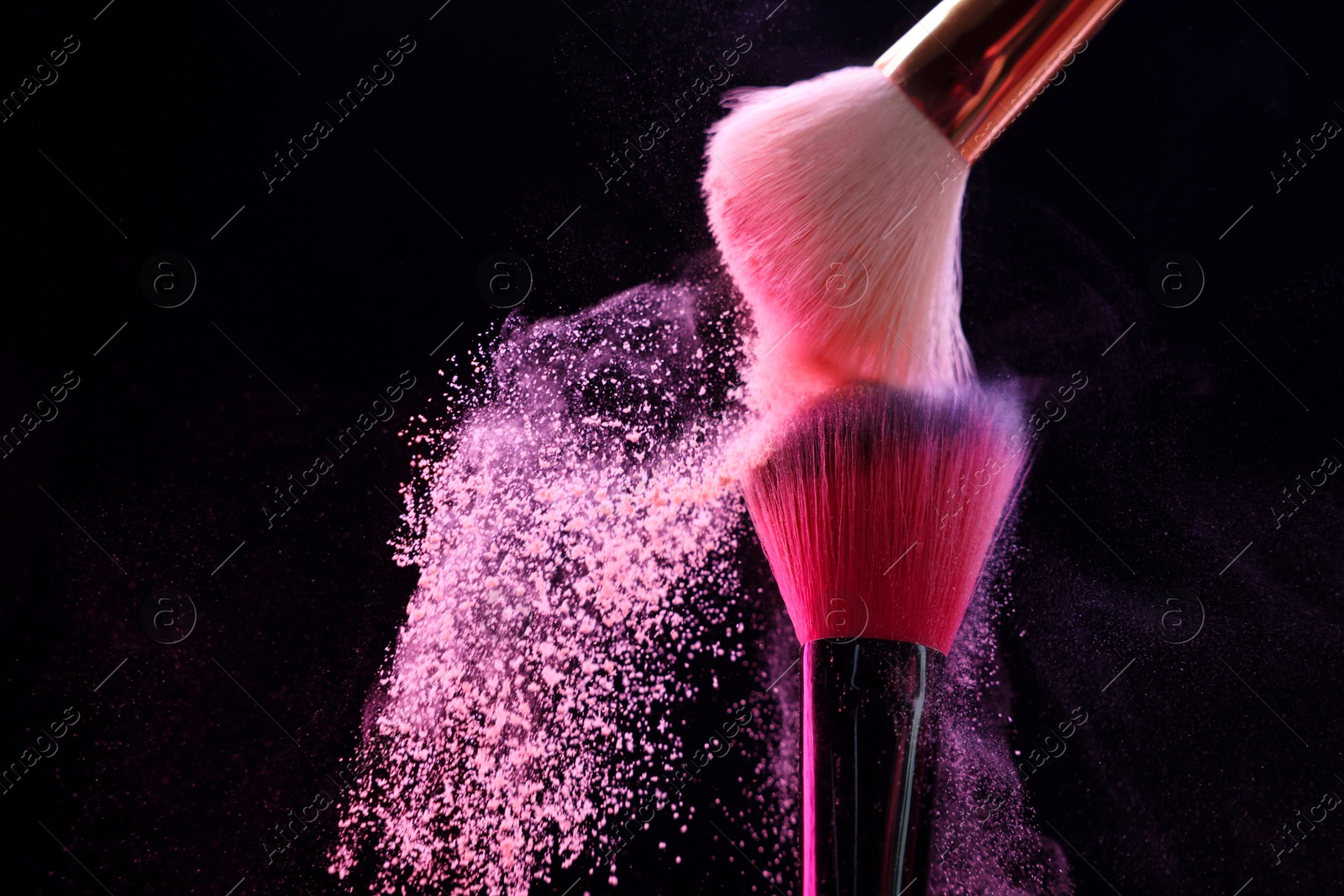 Makeup brushes with pink eye shadow on black background, closeup. Space for text Photo of Makeup brushes with pink eye shadow on black background, closeup. Space for text