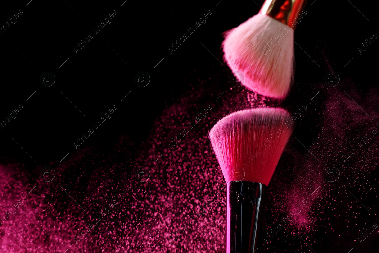 Makeup brushes with pink eye shadow on black background, closeup. Space for text Photo of Makeup brushes with pink eye shadow on black background, closeup. Space for text