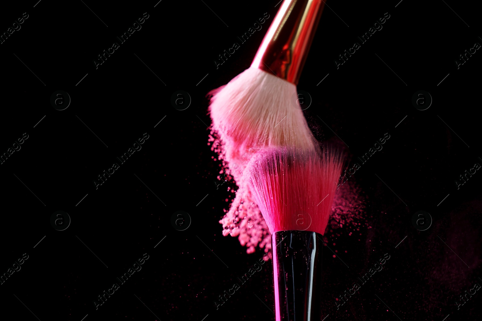 Makeup brushes with pink eye shadow on black background, closeup. Space for text Photo of Makeup brushes with pink eye shadow on black background, closeup. Space for text