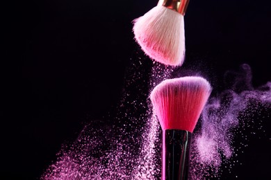 Photo of Makeup brushes with colorful eye shadows on black background, closeup. Space for text