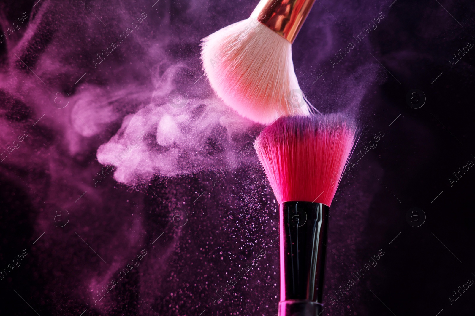 Makeup brushes with colorful eye shadows in neon lights on black background, closeup. Space for text Photo of Makeup brushes with colorful eye shadows in neon lights on black background, closeup. Space for text