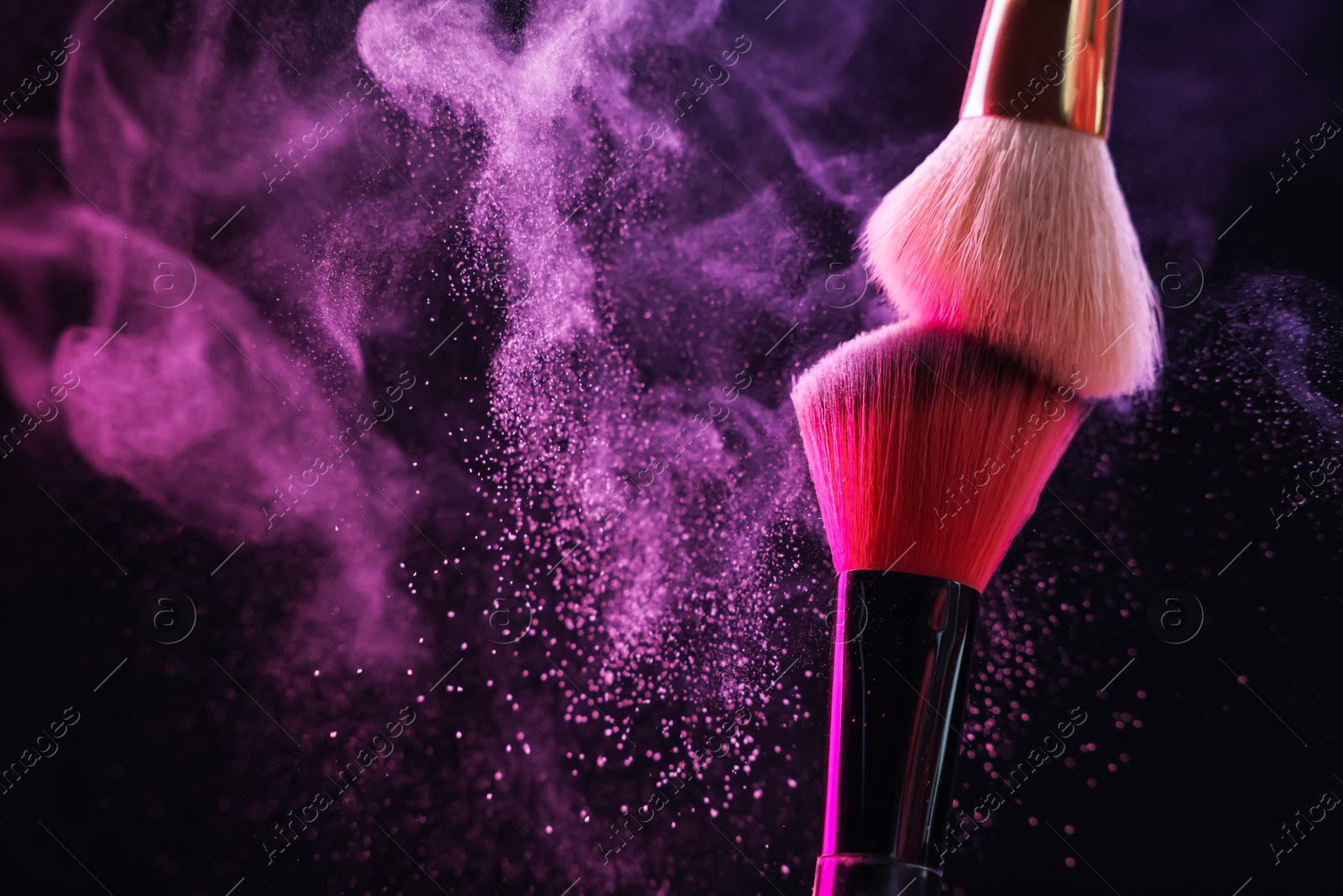 Makeup brushes with colorful eye shadows in neon lights on black background, closeup. Space for text Photo of Makeup brushes with colorful eye shadows in neon lights on black background, closeup. Space for text