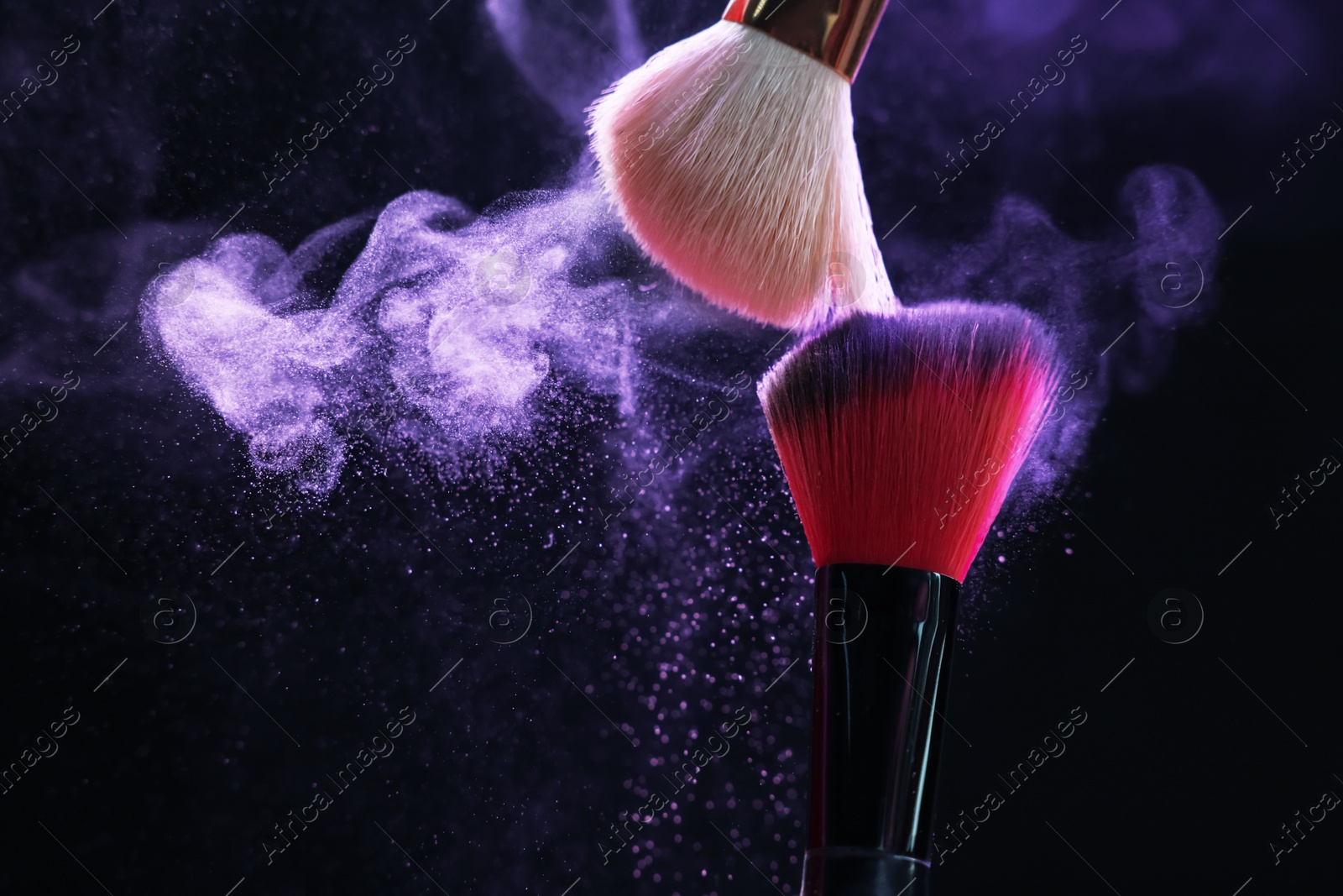 Makeup brushes with purple eye shadow on black background, closeup. Space for text Photo of Makeup brushes with purple eye shadow on black background, closeup. Space for text