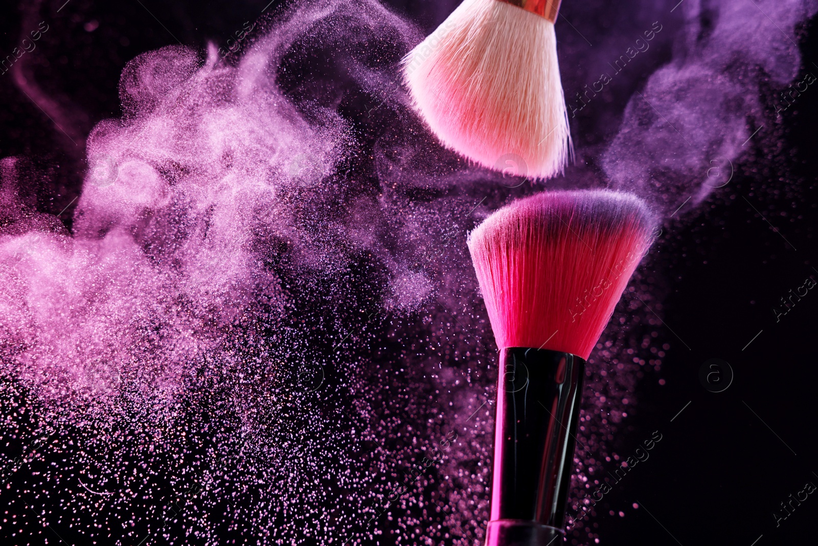 Makeup brushes with colorful eye shadows in neon lights on black background, closeup. Space for text Photo of Makeup brushes with colorful eye shadows in neon lights on black background, closeup. Space for text