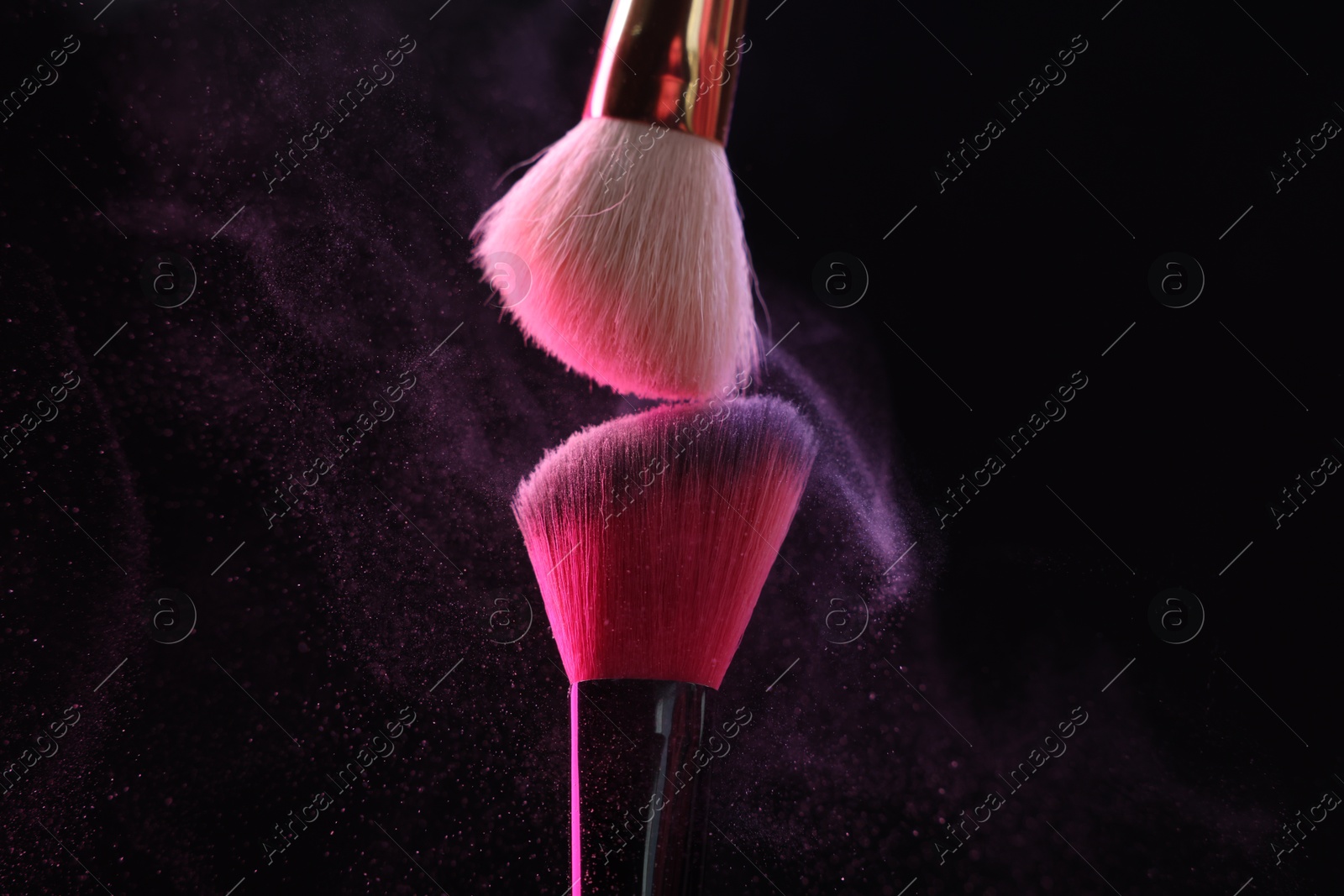 Makeup brushes with color eye shadow on black background, closeup Photo of Makeup brushes with color eye shadow on black background, closeup