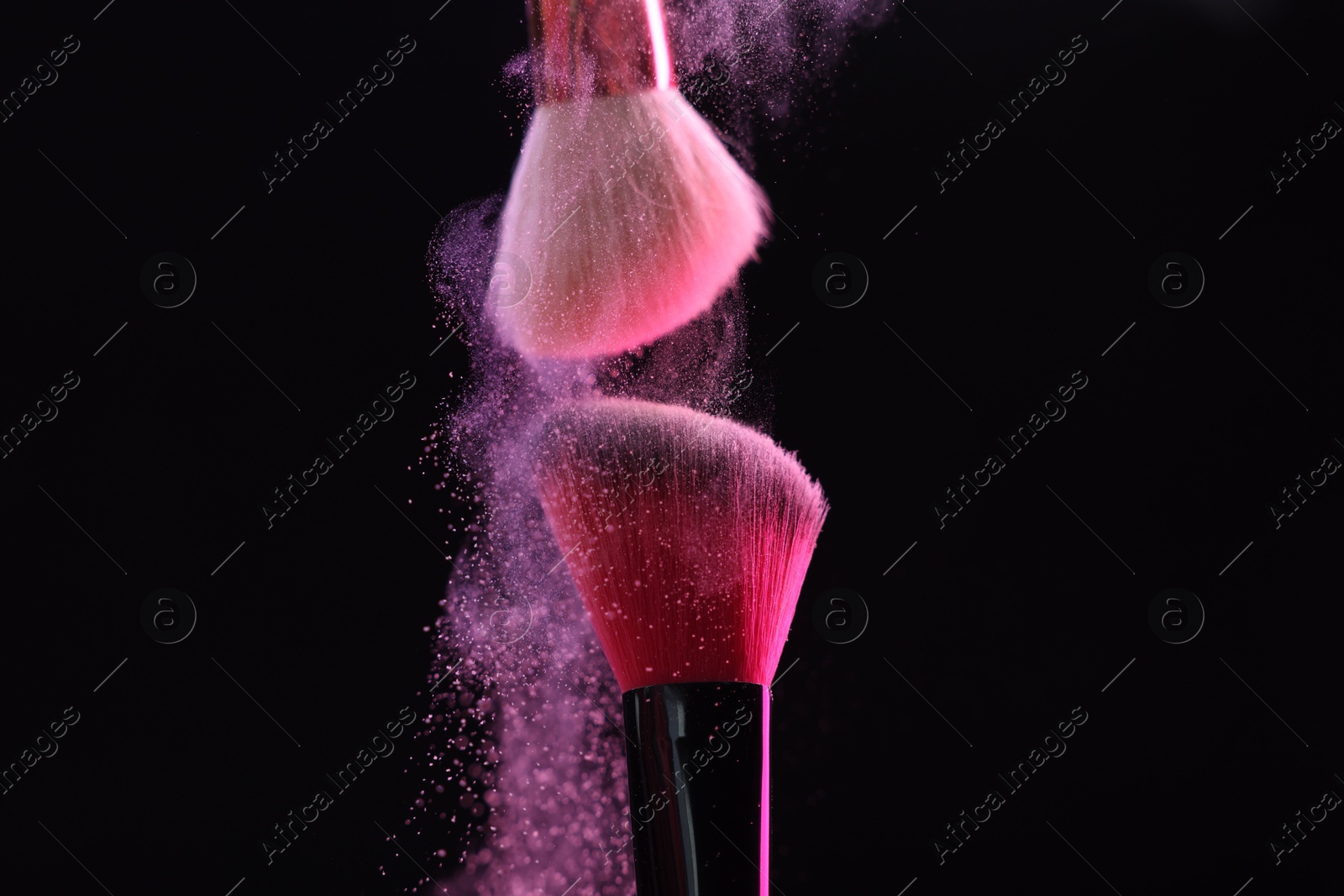 Makeup brushes with color eye shadow on black background, closeup Photo of Makeup brushes with color eye shadow on black background, closeup