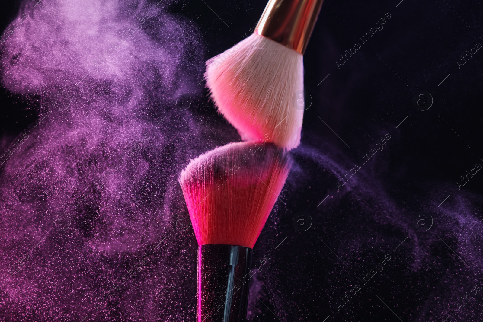 Makeup brushes with color eye shadow on black background, closeup Photo of Makeup brushes with color eye shadow on black background, closeup