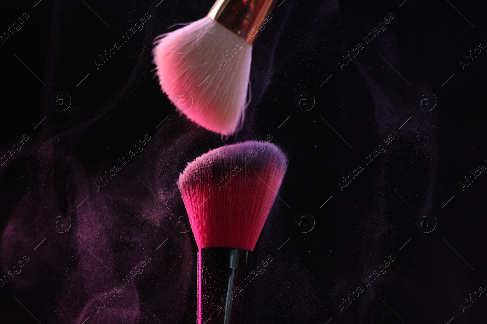 Makeup brushes with colorful eye shadows on black background, closeup Photo of Makeup brushes with colorful eye shadows on black background, closeup