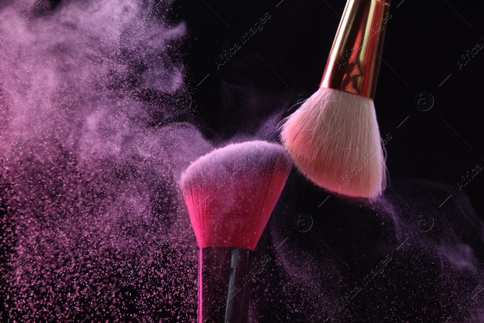 Makeup brushes with colorful eye shadows on black background, closeup Photo of Makeup brushes with colorful eye shadows on black background, closeup