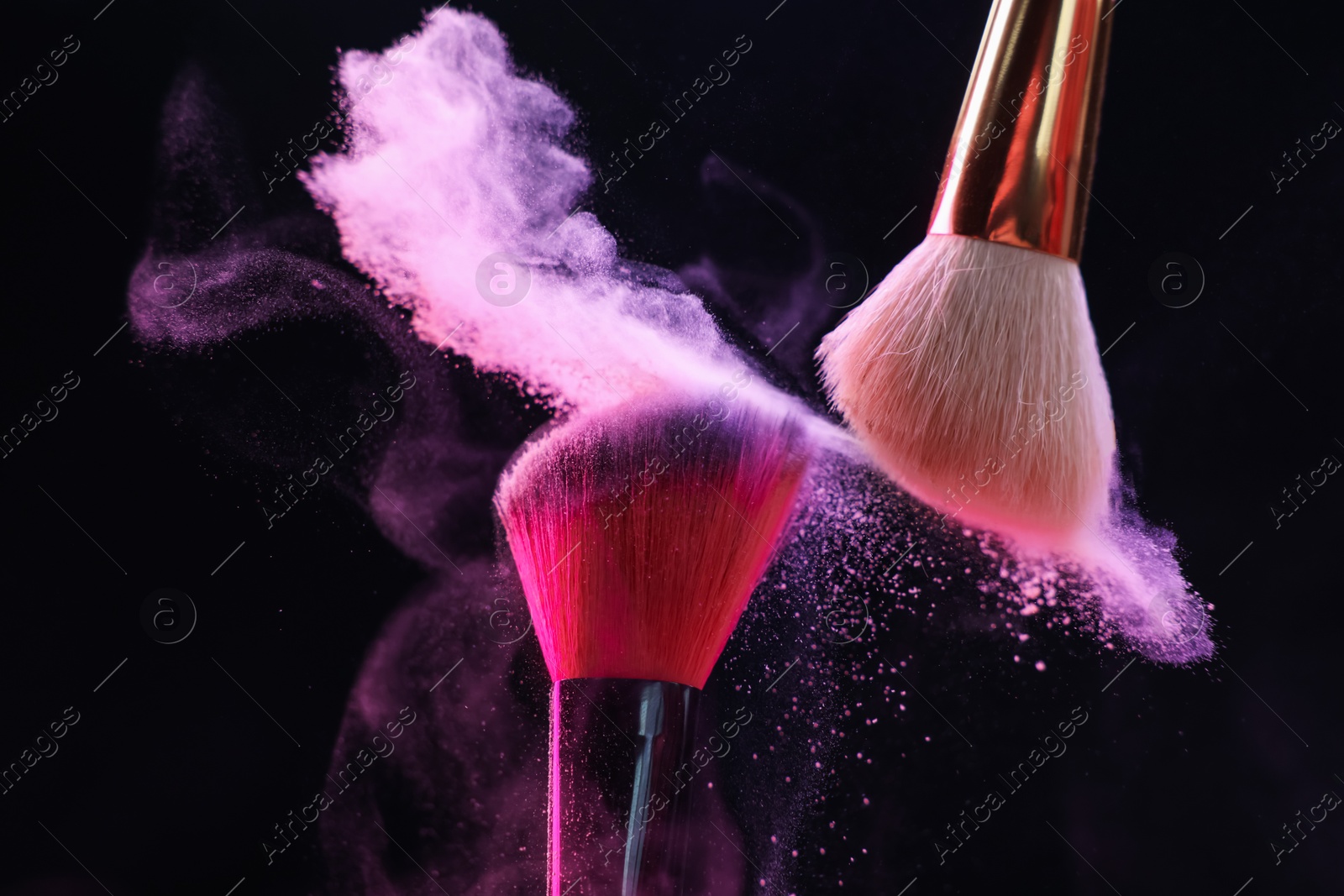 Makeup brushes with colorful eye shadows on black background, closeup Photo of Makeup brushes with colorful eye shadows on black background, closeup
