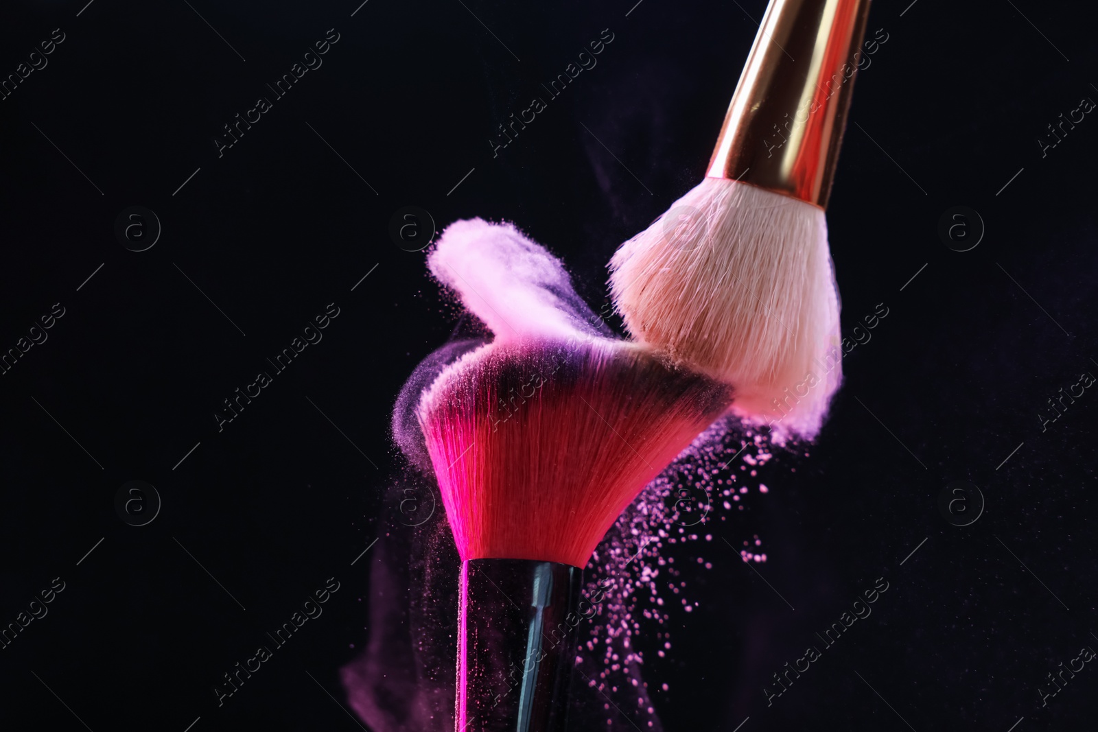 Makeup brushes with colorful eye shadows on black background, closeup Photo of Makeup brushes with colorful eye shadows on black background, closeup