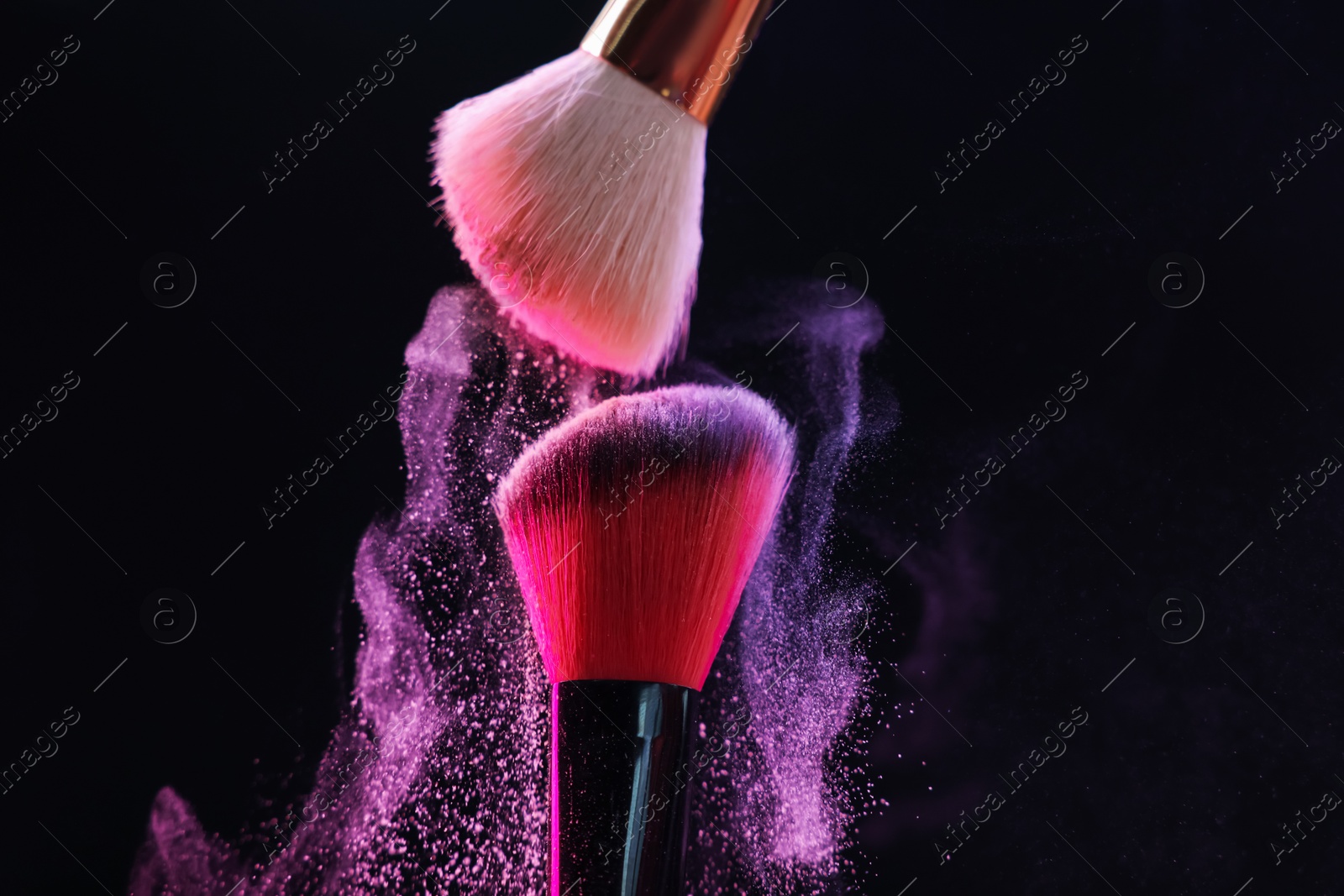 Makeup brushes with colorful eye shadows on black background, closeup Photo of Makeup brushes with colorful eye shadows on black background, closeup