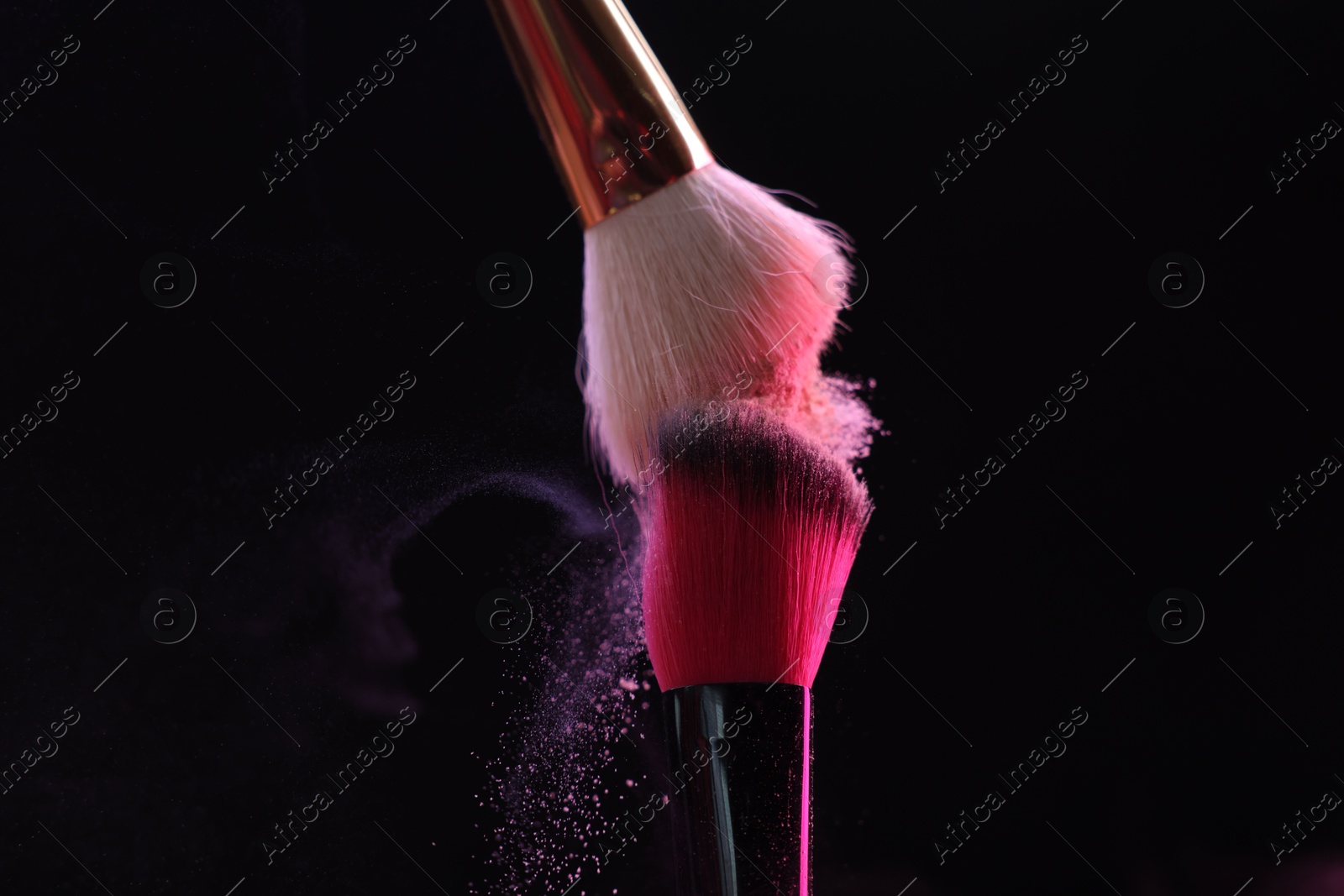 Makeup brushes with colorful eye shadows on black background, closeup Photo of Makeup brushes with colorful eye shadows on black background, closeup