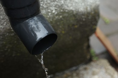 Photo of Water dripping from drain pipe outdoors, above view