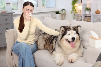 Photo of Woman suffering from allergy with her dog at home
