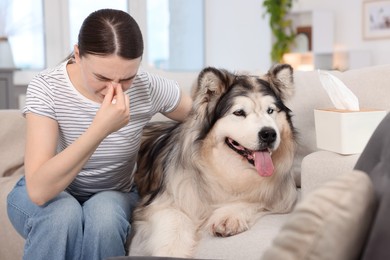 Photo of Woman suffering from allergy with her dog at home