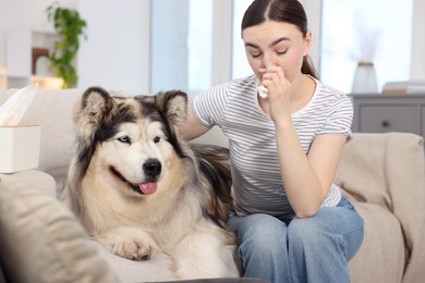 Photo of Woman suffering from allergy with her dog at home