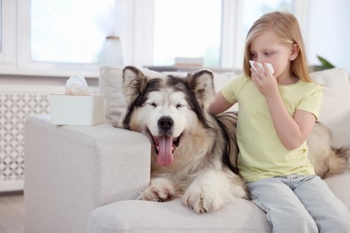 Photo of Girl suffering from allergy with her dog at home