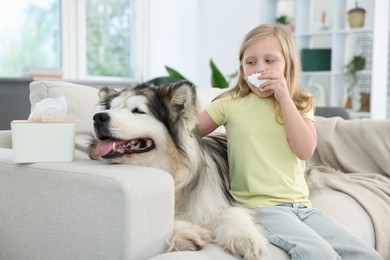 Photo of Girl suffering from allergy with her dog at home