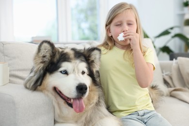 Photo of Girl suffering from allergy with her dog at home