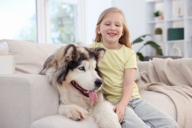 Photo of Girl suffering from allergy with her dog at home