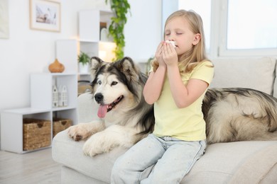 Photo of Girl suffering from allergy with her dog at home