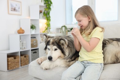 Photo of Girl suffering from allergy with her dog at home
