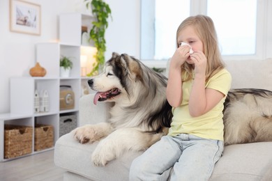 Photo of Girl suffering from allergy with her dog at home
