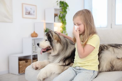Photo of Girl suffering from allergy with her dog at home