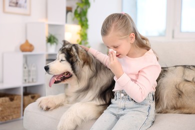 Photo of Girl suffering from allergy with her dog at home