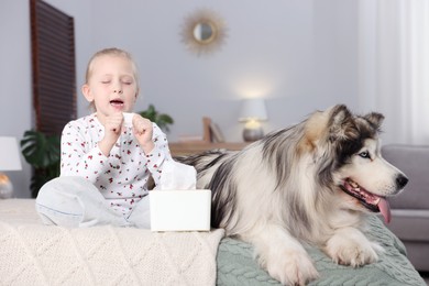 Photo of Girl suffering from allergy with her dog on bed at home