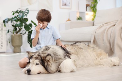 Photo of Boy suffering from allergy with her dog at home