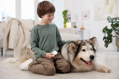 Photo of Happy boy and cute dog at home