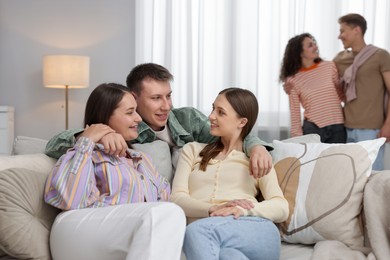 Photo of Friends hugging each other indoors, selective focus