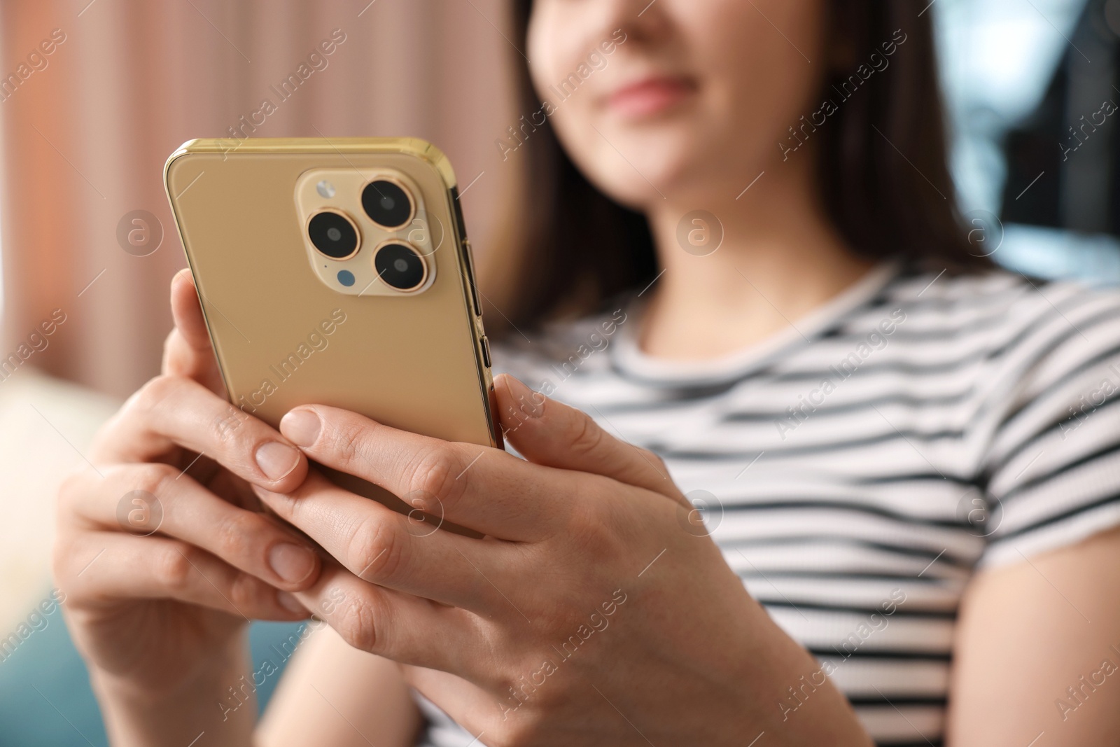 Woman using modern smartphone at home, closeup Photo of Woman using modern smartphone at home, closeup