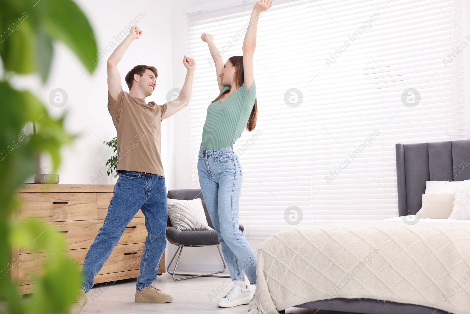Happy young couple dancing together in bedroom Photo of Happy young couple dancing together in bedroom