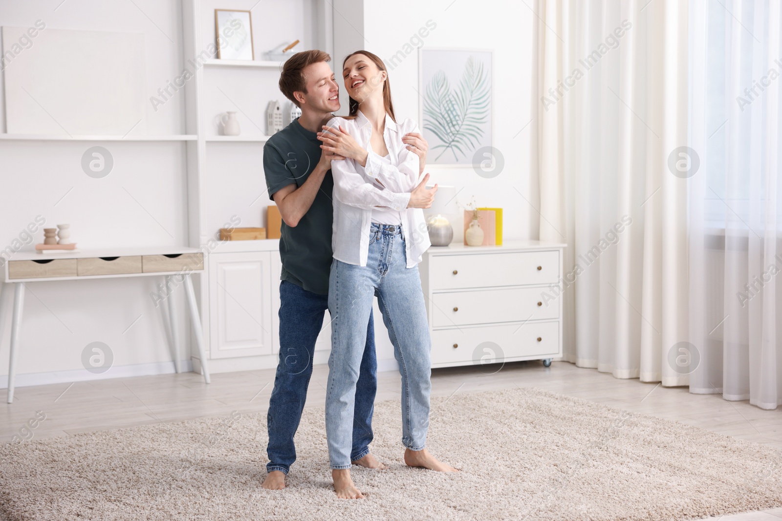 Happy young couple dancing together at home Photo of Happy young couple dancing together at home