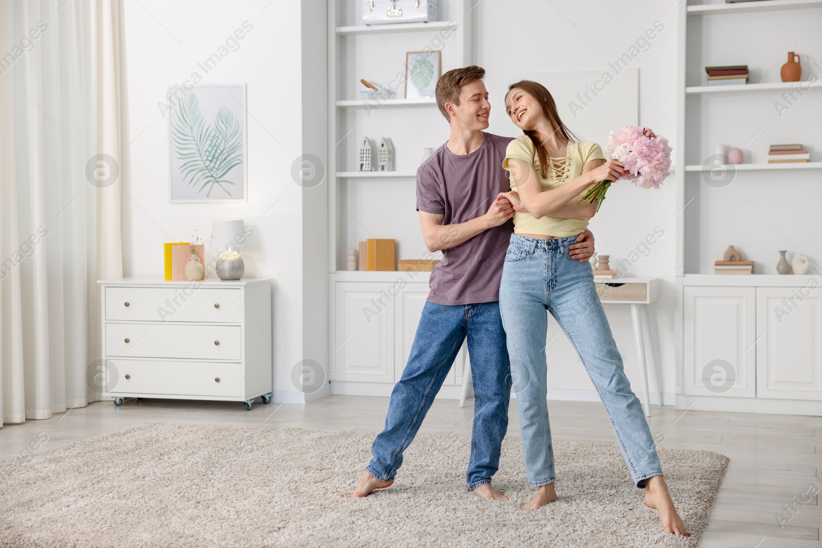 Happy young couple dancing together at home Photo of Happy young couple dancing together at home