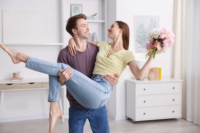 Photo of Happy young couple dancing together at home