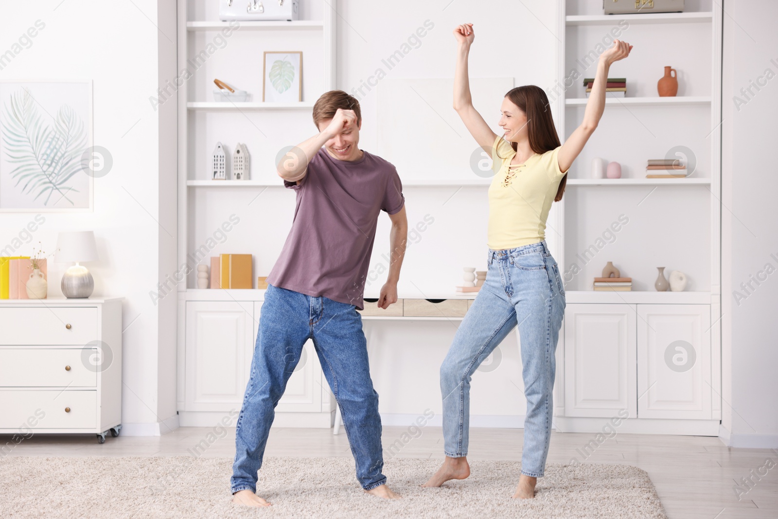 Happy young couple dancing together at home Photo of Happy young couple dancing together at home