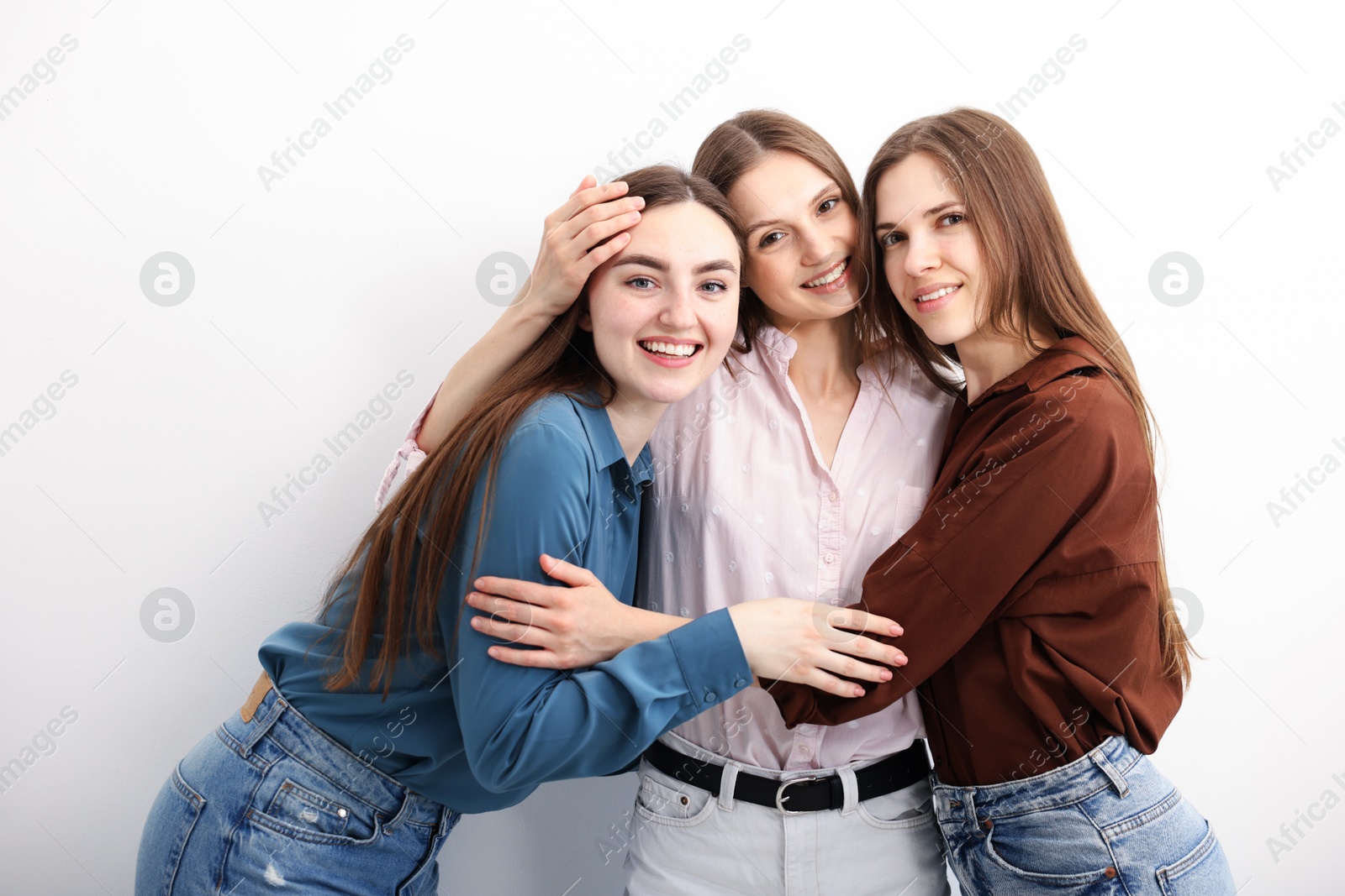 Friends hugging each other on white background Photo of Friends hugging each other on white background