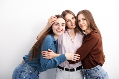 Photo of Friends hugging each other on white background