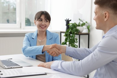 Photo of Consultant working with client at table in office. Business meeting