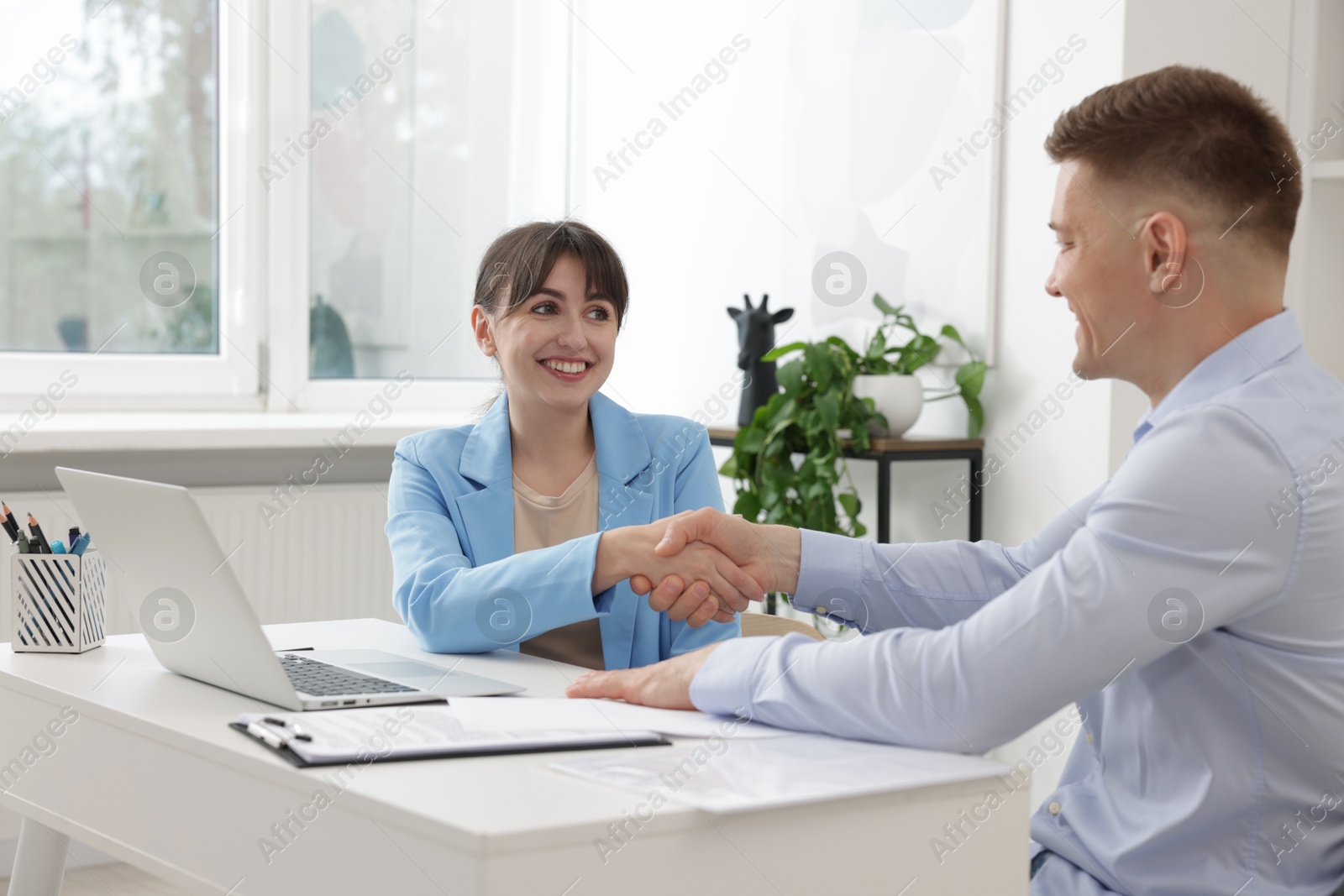 Consultant working with client at table in office. Business meeting Photo of Consultant working with client at table in office. Business meeting