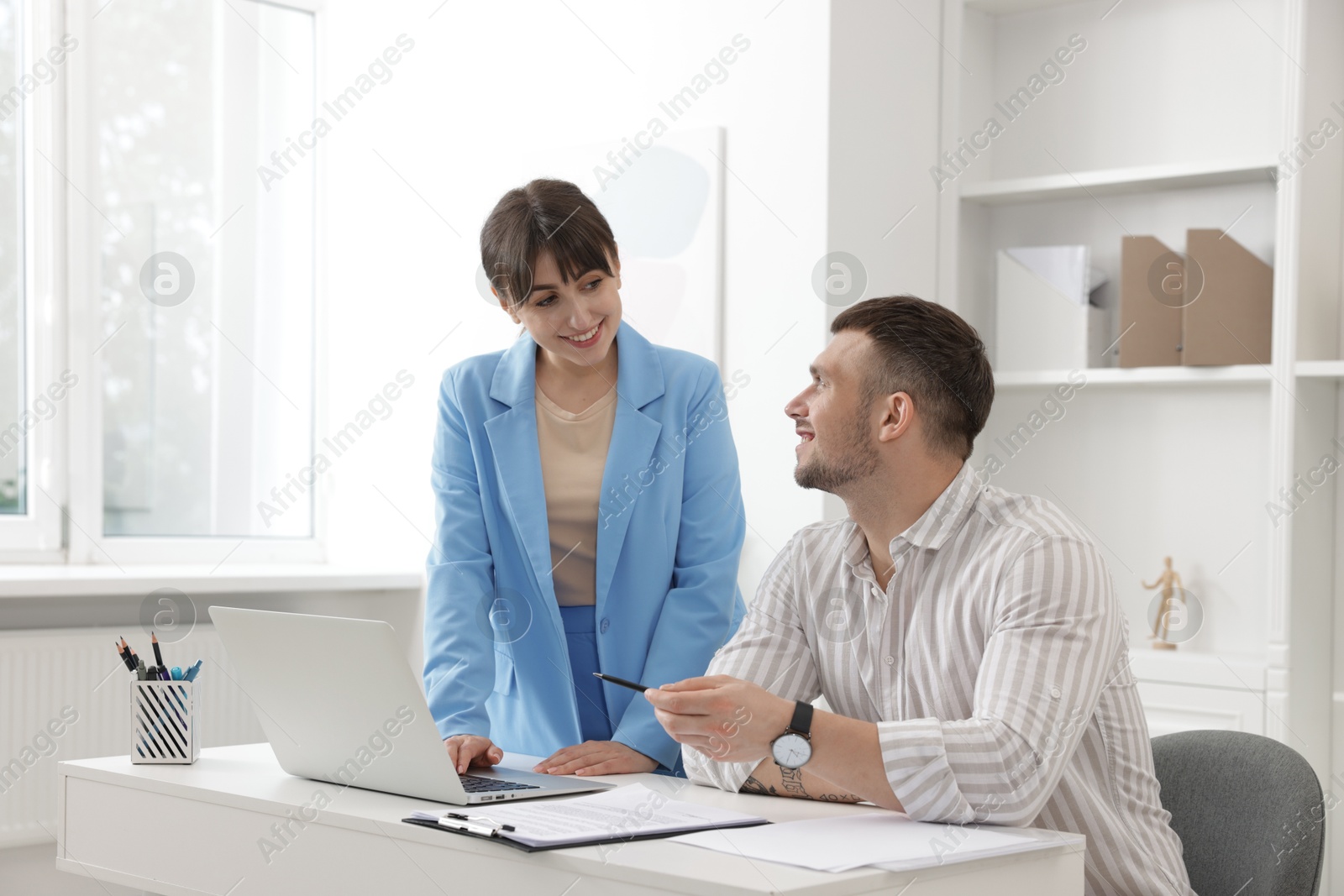 Consultant working with client at table in office. Business meeting Photo of Consultant working with client at table in office. Business meeting