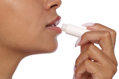 Photo of Woman applying lip balm onto her lips on white background, closeup