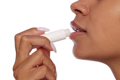 Photo of Woman applying lip balm onto her lips on white background, closeup